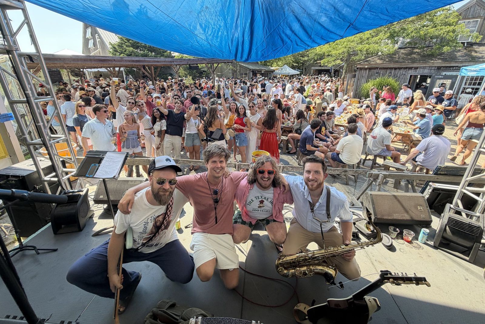 Dawson and the band on stage in front of a packed outdoor crowd